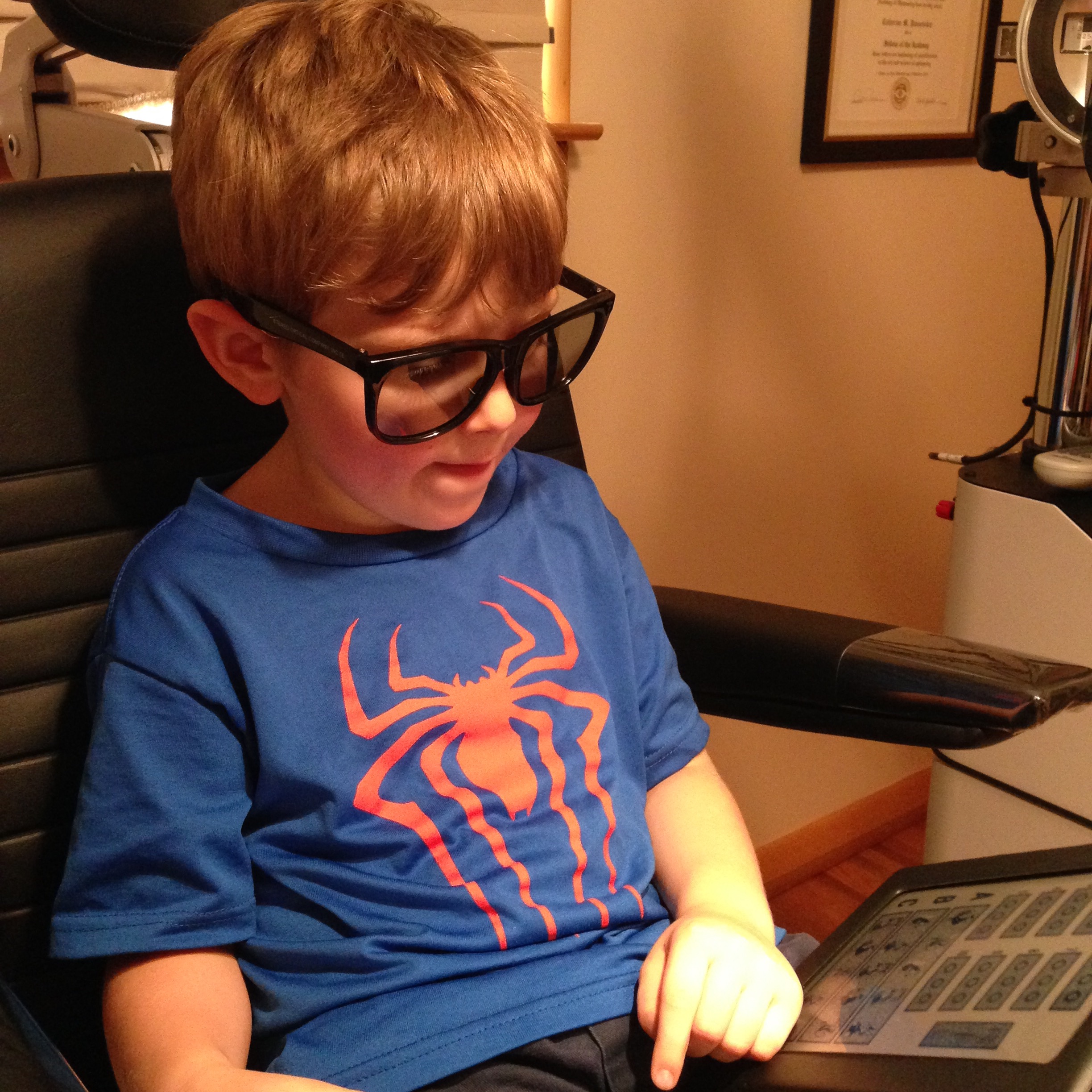 image of Dr. Cathy Pannebaker performing a eye exam with a young boy